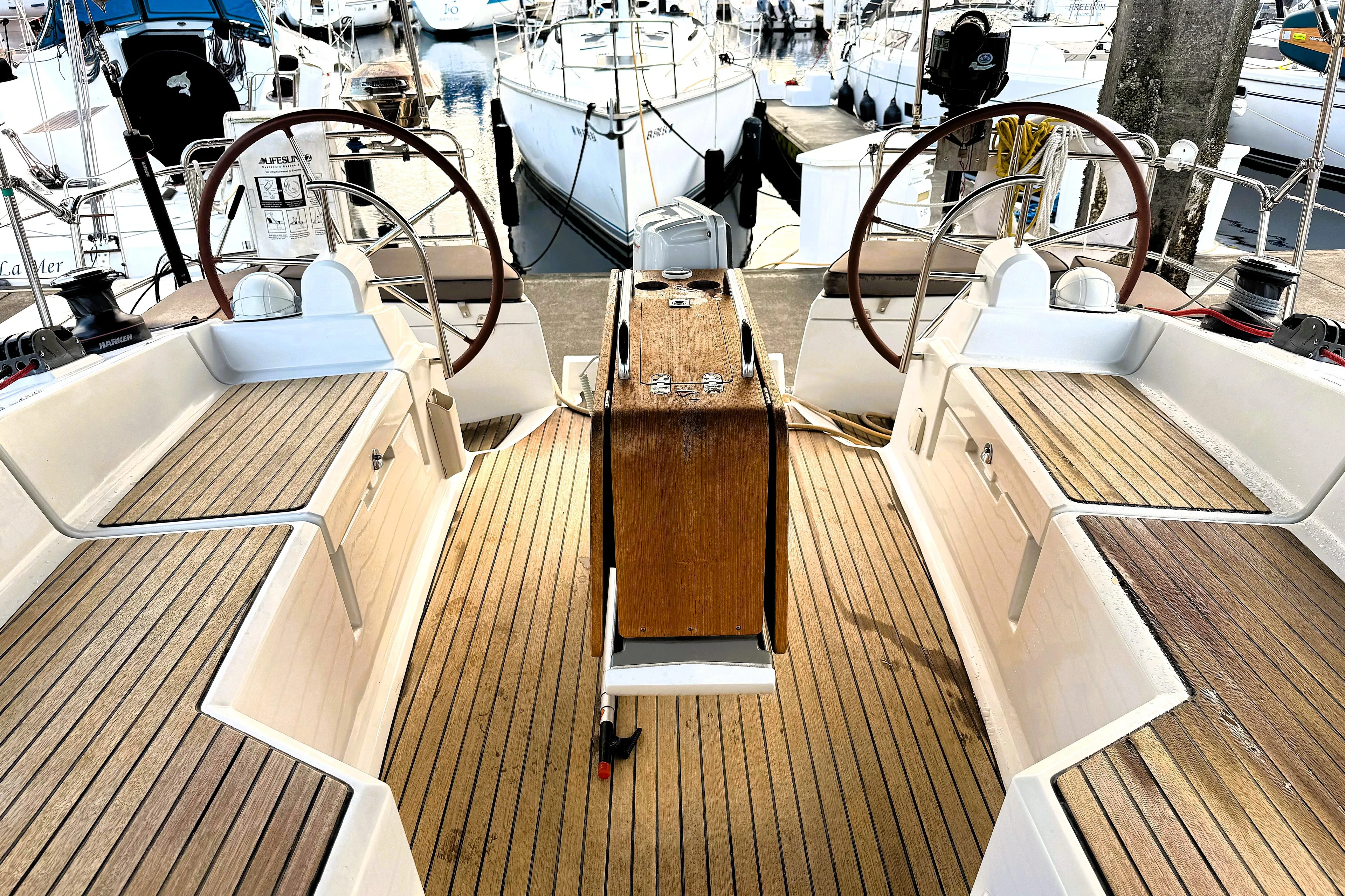 Falcor Yacht Photos Pics 2013 Jeanneau Sun Odyssey 44 DS cockpit with dual steering wheels and teak flooring.