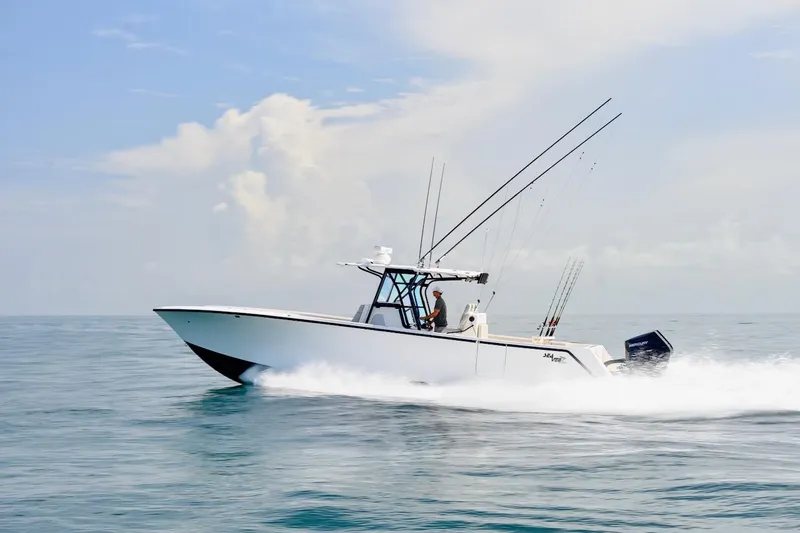  Yacht Photos Pics 2023 SeaVee 370Z boat cruising on open water, equipped with fishing rods.