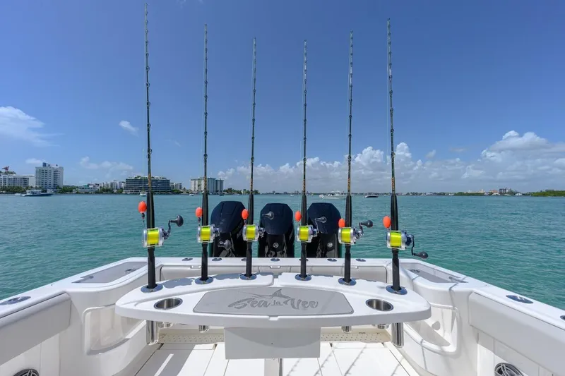  Yacht Photos Pics 2023 SeaVee 370Z boat with fishing rods, ocean view, and clear blue sky.