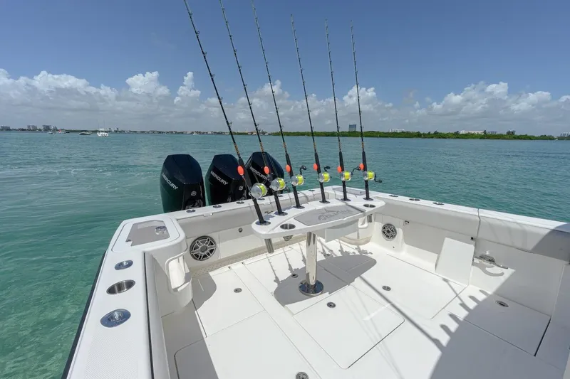  Yacht Photos Pics 2023 SeaVee 370Z boat with fishing rods and Mercury engines on open water.