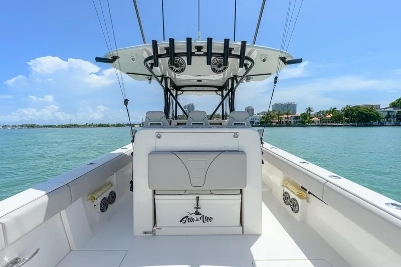  Yacht Photos Pics 2023 SeaVee 370Z boat interior with helm, ocean view, and clear blue sky.