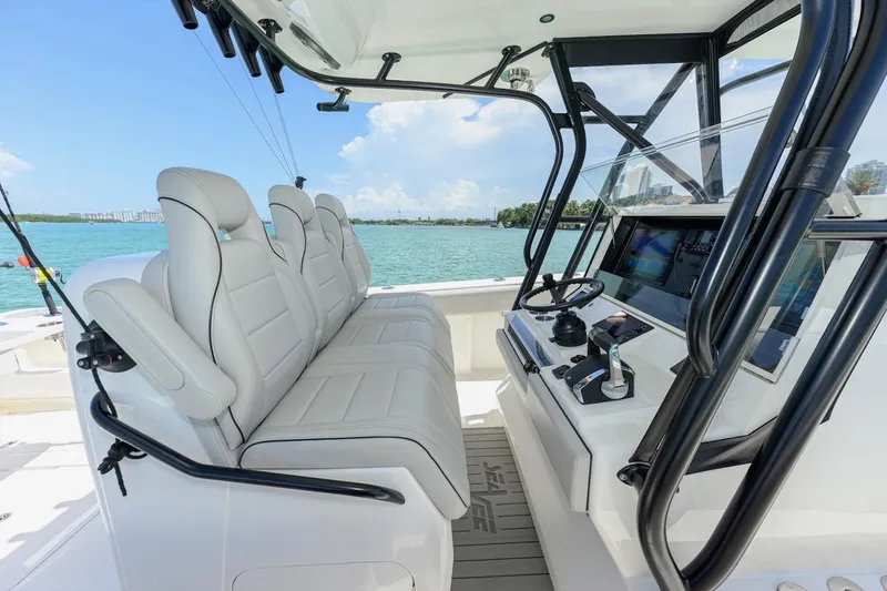  Yacht Photos Pics 2023 SeaVee 370Z boat interior with modern helm and seating, overlooking serene waters.