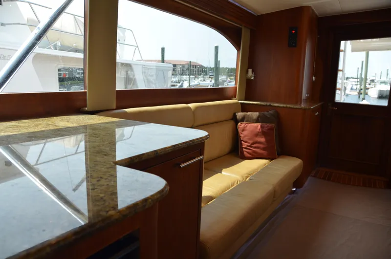 Cuda Yacht Photos Pics Luxurious interior of 2001 Buddy Davis 61 yacht with plush seating and elegant wood finishes.