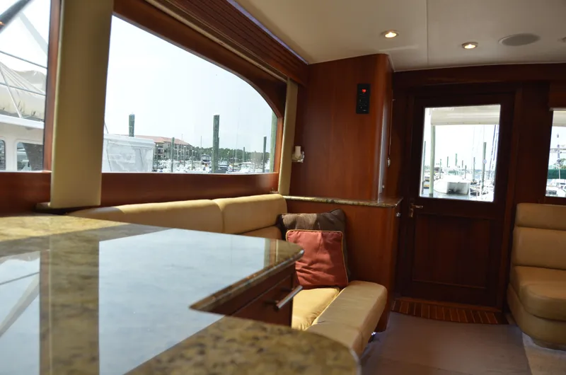 Cuda Yacht Photos Pics Interior of 2001 Buddy Davis 61 yacht with elegant seating and marina view.