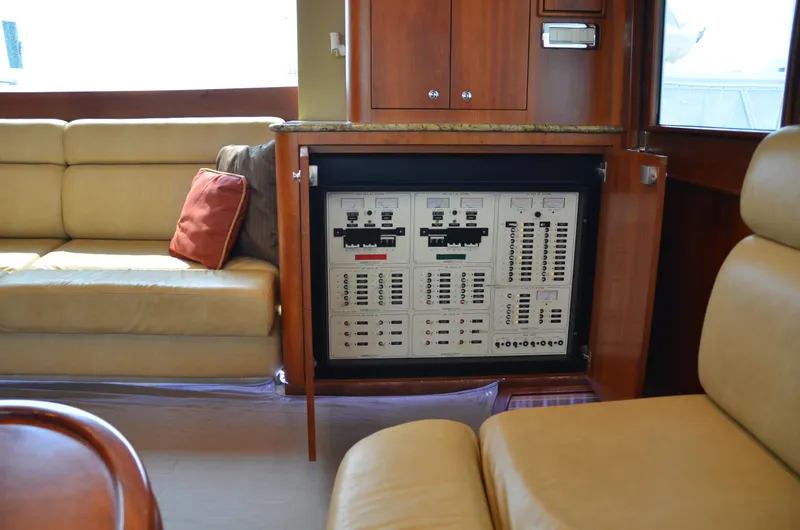 Cuda Yacht Photos Pics Interior of 2001 Buddy Davis 61 yacht with control panel and beige seating.