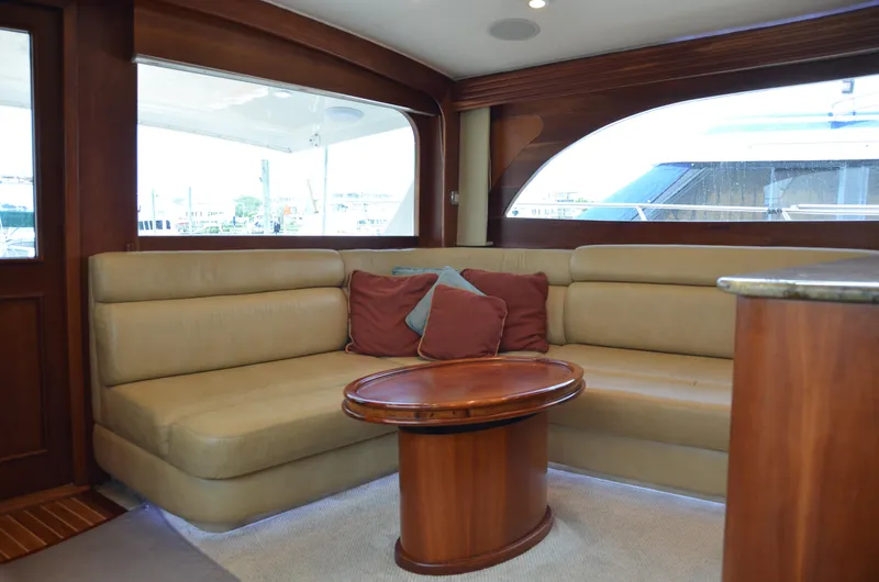 Cuda Yacht Photos Pics Luxurious interior of 2001 Buddy Davis 61 yacht with plush seating and wooden table.