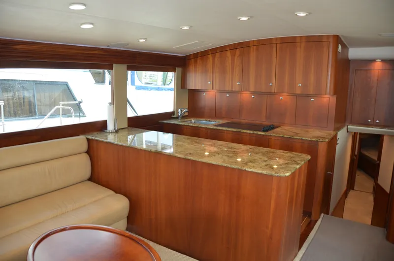 Cuda Yacht Photos Pics Luxurious interior of 2001 Buddy Davis 61 yacht with elegant wood cabinetry and granite countertops.
