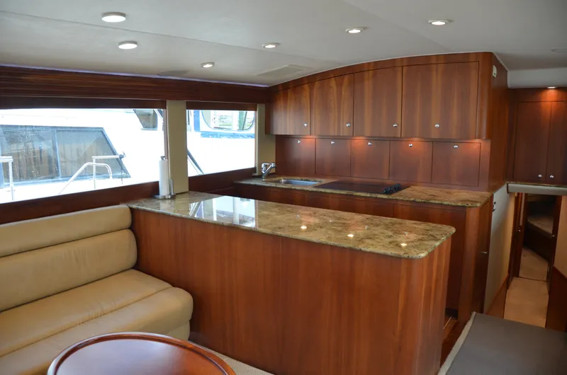 Cuda Yacht Photos Pics Luxurious interior of 2001 Buddy Davis 61 yacht with elegant wood cabinetry and granite countertops.