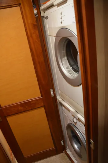 Cuda Yacht Photos Pics Stacked washer and dryer in a 2001 Buddy Davis 61 yacht interior.