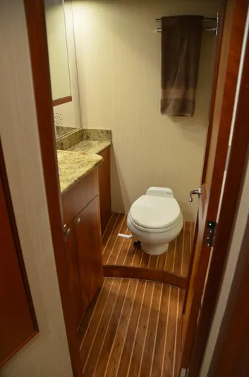 Cuda Yacht Photos Pics Bathroom interior of 2001 Buddy Davis 61 yacht with wooden flooring and granite countertop.
