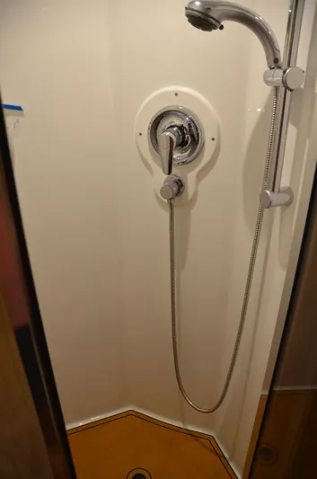 Cuda Yacht Photos Pics Shower area in 2001 Buddy Davis 61 yacht, featuring chrome fixtures and handheld showerhead.