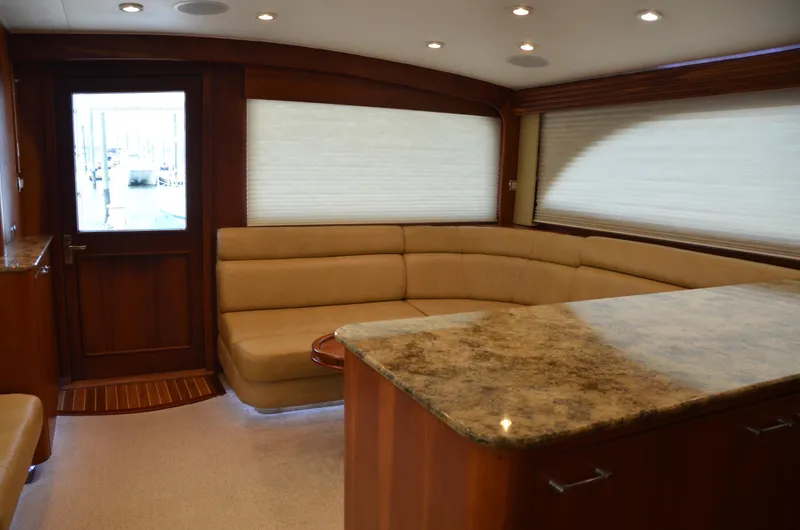 Cuda Yacht Photos Pics Luxurious interior of a 2001 Buddy Davis 61 yacht with plush seating and elegant wood finishes.