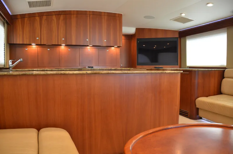 Cuda Yacht Photos Pics Luxurious interior of 2001 Buddy Davis 61 yacht with wood cabinetry and seating.