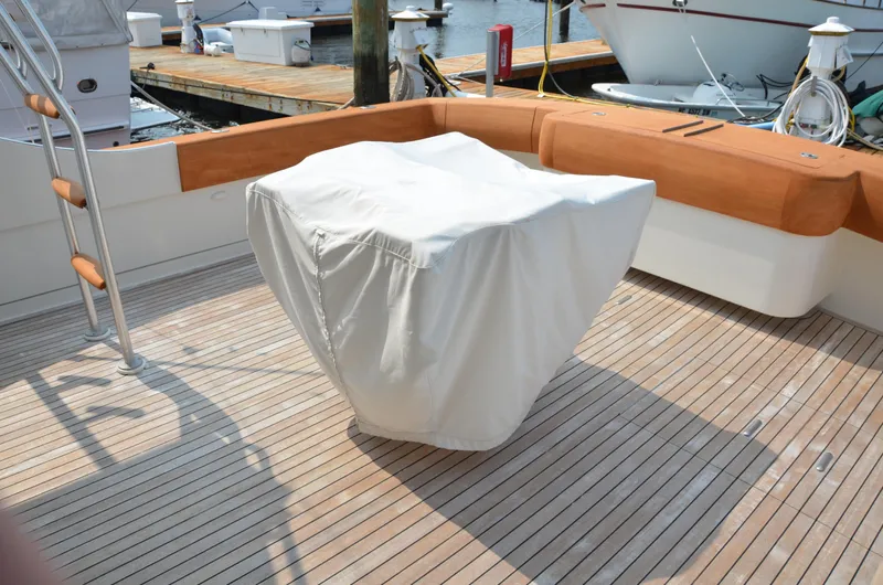 Cuda Yacht Photos Pics Covered equipment on deck of 2001 Buddy Davis 61 yacht, with wooden flooring and docked boats.