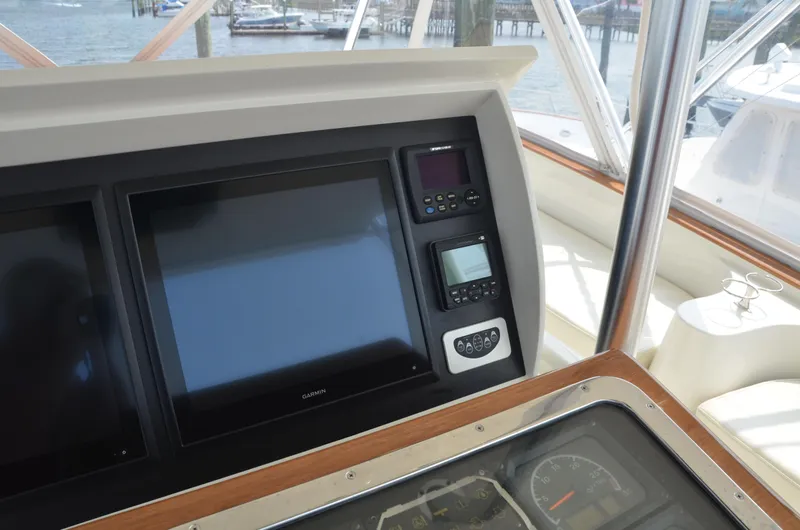 Cuda Yacht Photos Pics Control panel of a 2001 Buddy Davis 61 boat with navigation screens and gauges.