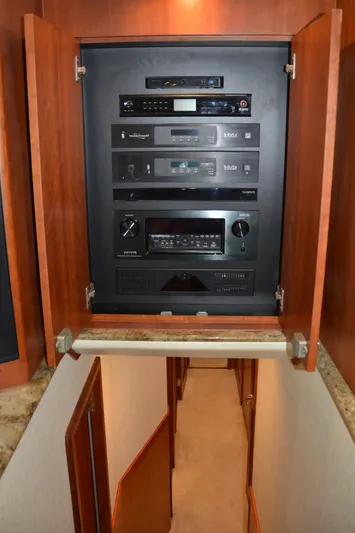 Cuda Yacht Photos Pics Audio-visual equipment cabinet on 2001 Buddy Davis 61 yacht, with open wooden doors.