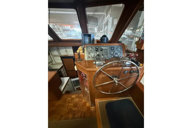 Island Time Yacht Photos Pics 1983 Ocean Alexander 43 Flush Aft Deck helm with classic wooden steering wheel and instrument panel.