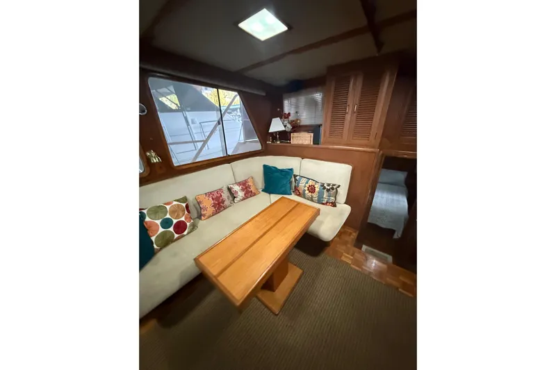 Island Time Yacht Photos Pics Interior of 1983 Ocean Alexander 43 Flush Aft Deck with cozy seating and colorful pillows.