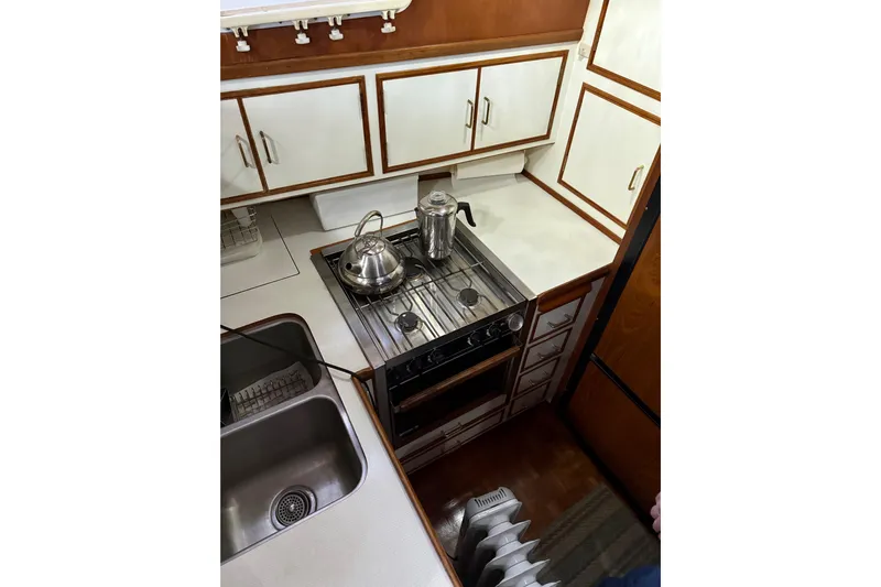 Island Time Yacht Photos Pics 1983 Ocean Alexander 43 Flush Aft Deck yacht kitchen with stove, sink, and cabinets.