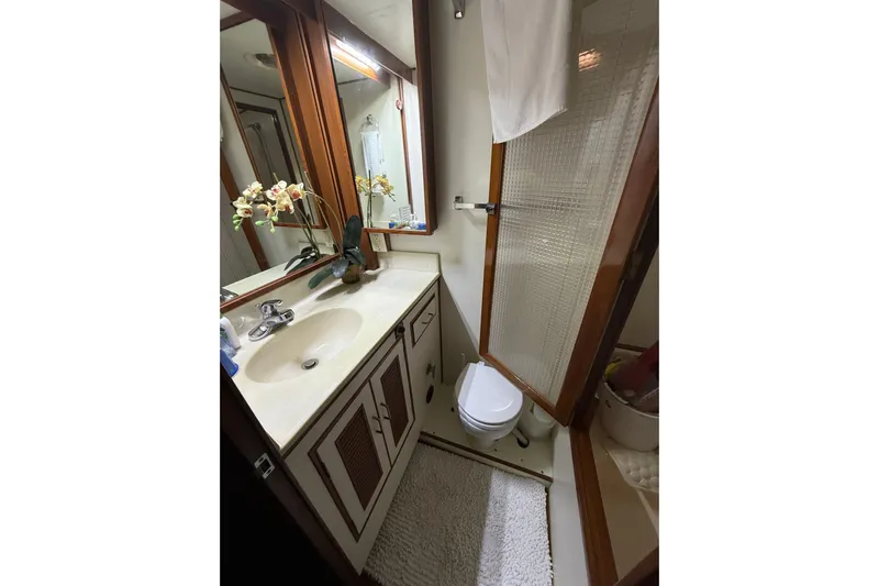 Island Time Yacht Photos Pics Bathroom interior of 1983 Ocean Alexander 43 Flush Aft Deck yacht, featuring sink and shower.