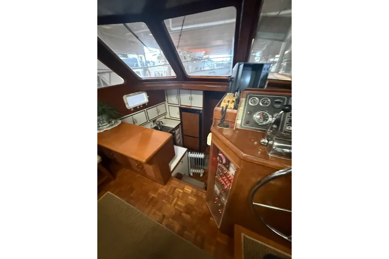 Island Time Yacht Photos Pics 1983 Ocean Alexander 43 Flush Aft Deck interior with helm, wood finish, and navigation instruments.