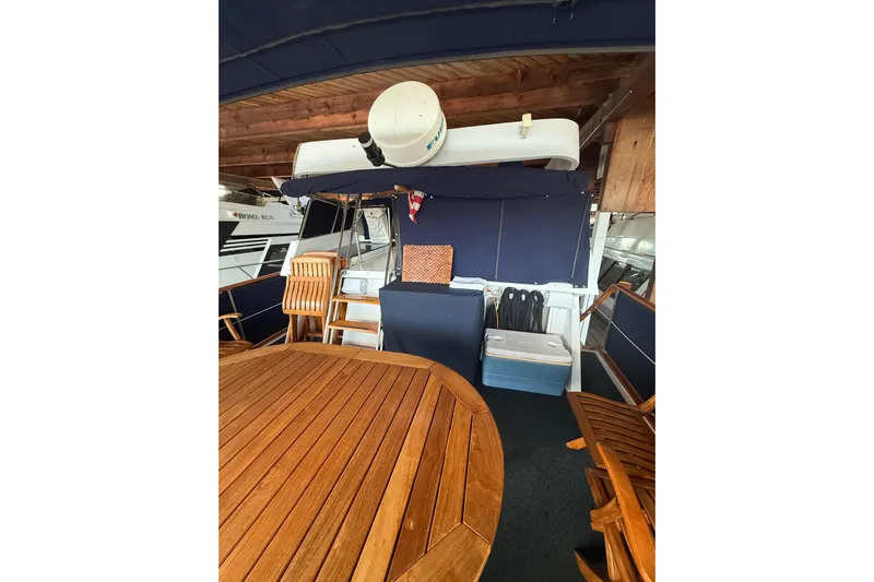 Island Time Yacht Photos Pics 1983 Ocean Alexander 43 Flush Aft Deck with wooden furniture and nautical decor.