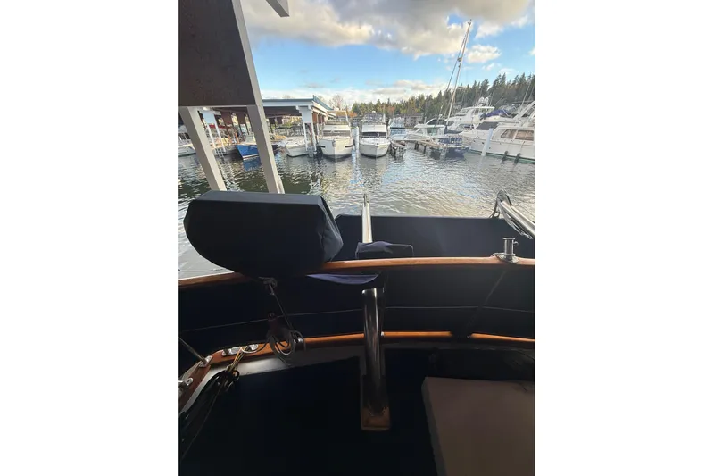 Island Time Yacht Photos Pics 1983 Ocean Alexander 43 Flush Aft Deck yacht view at marina with boats and cloudy sky.