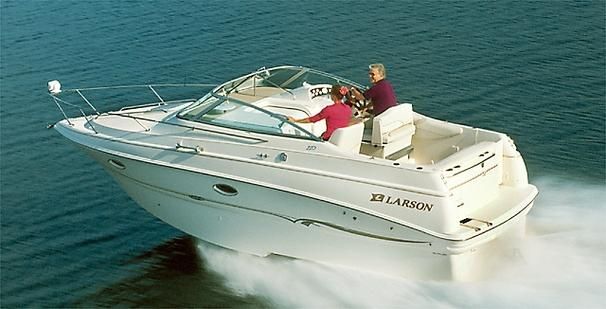 2001 Larson Cabrio 270 boat cruising on open water with two passengers.