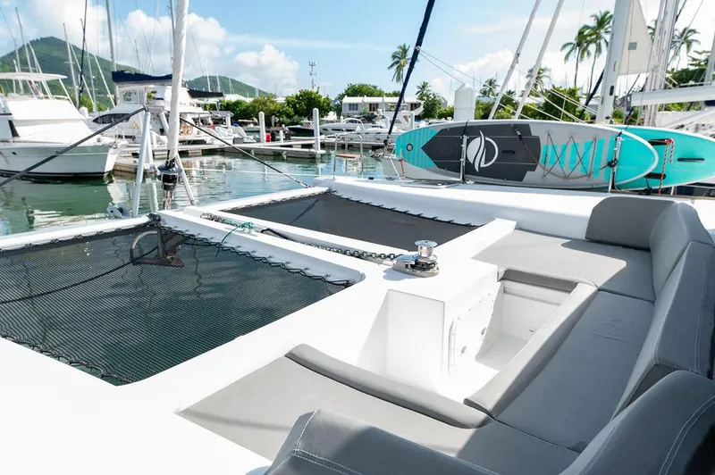 Miss Summer Yacht Photos Pics Lagoon 450 catamaran, 2014 model, docked with paddleboard on deck, surrounded by other boats.