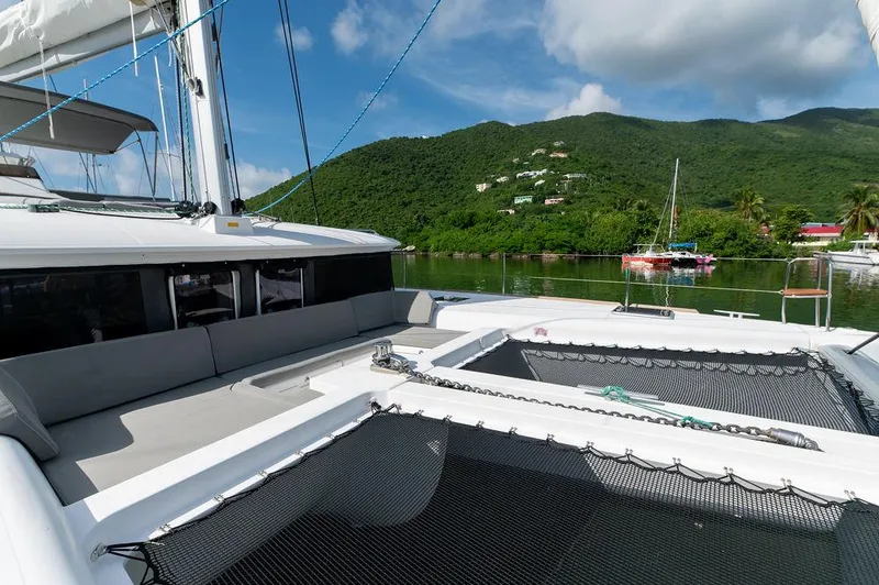 Miss Summer Yacht Photos Pics 2014 Lagoon 450 catamaran with scenic mountain backdrop and clear blue sky.