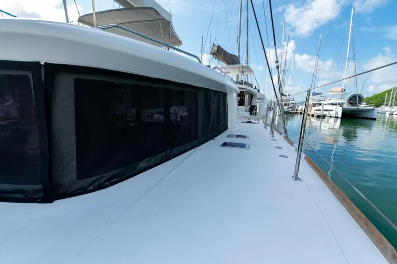 Miss Summer Yacht Photos Pics 2014 Lagoon 450 catamaran docked in a marina, showcasing sleek design and spacious deck.