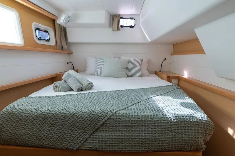 Miss Summer Yacht Photos Pics Cozy bedroom in 2014 Lagoon 450 yacht with neatly arranged bed and natural light.
