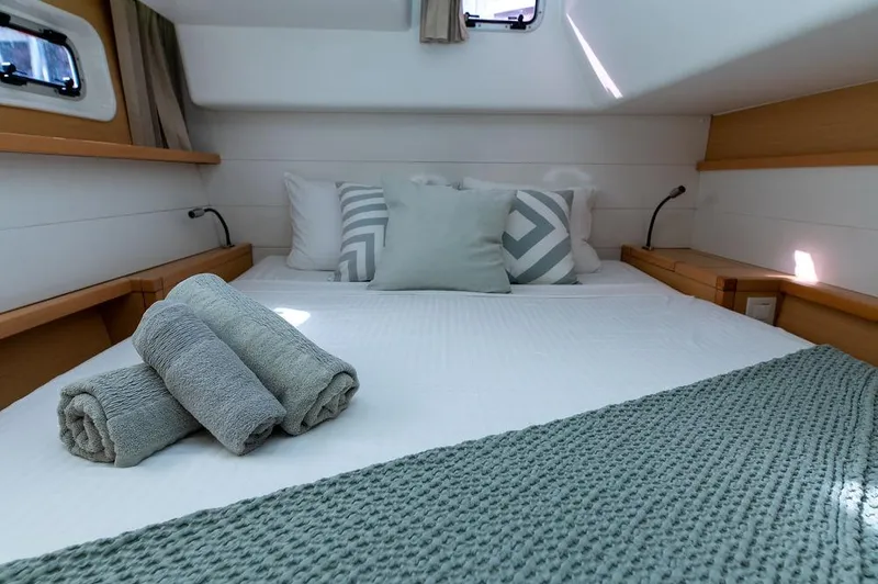 Miss Summer Yacht Photos Pics Luxurious cabin interior of 2014 Lagoon 450 catamaran with cozy bedding and soft towels.