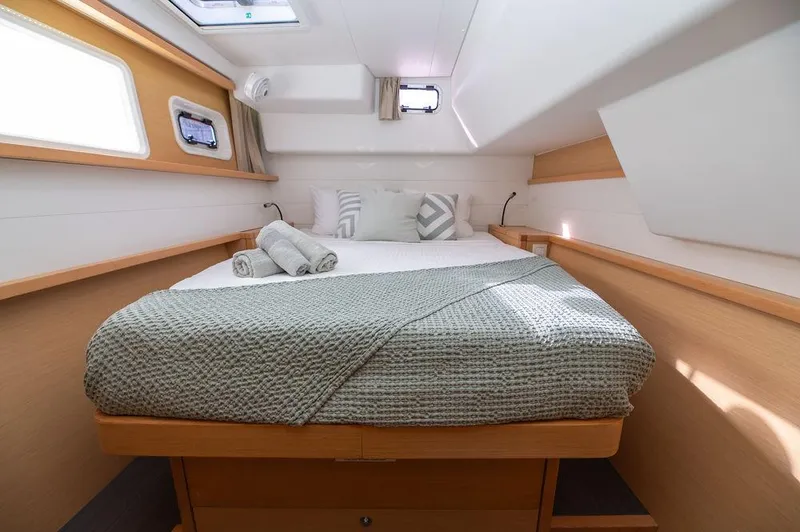 Miss Summer Yacht Photos Pics Cozy cabin interior of 2014 Lagoon 450 yacht with neatly made bed and natural light.