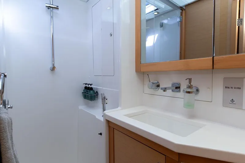 Miss Summer Yacht Photos Pics Bathroom interior of 2014 Lagoon 450 yacht, featuring modern fixtures and a sleek design.