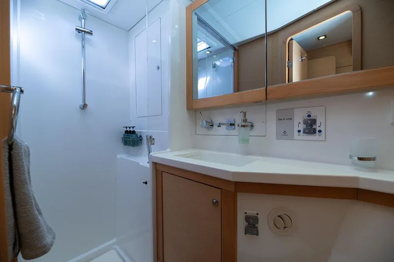 Miss Summer Yacht Photos Pics Modern bathroom interior of 2014 Lagoon 450 yacht, featuring sleek fixtures and ample storage.