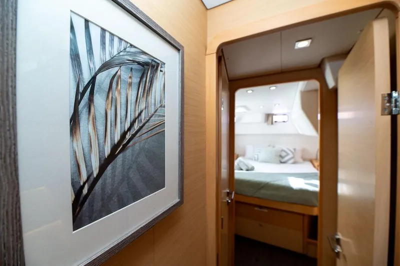 Miss Summer Yacht Photos Pics Interior of 2014 Lagoon 450 yacht, featuring a cozy bedroom and framed artwork.