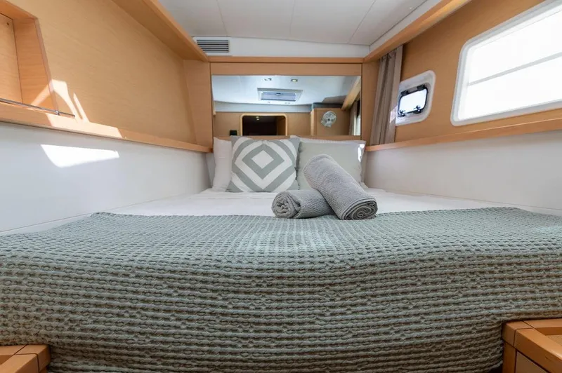 Miss Summer Yacht Photos Pics Luxurious cabin interior of 2014 Lagoon 450 catamaran with cozy bedding and natural light.