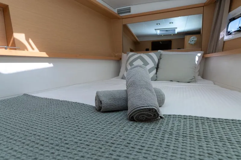 Miss Summer Yacht Photos Pics Luxurious cabin interior of 2014 Lagoon 450 yacht with neatly arranged towels.