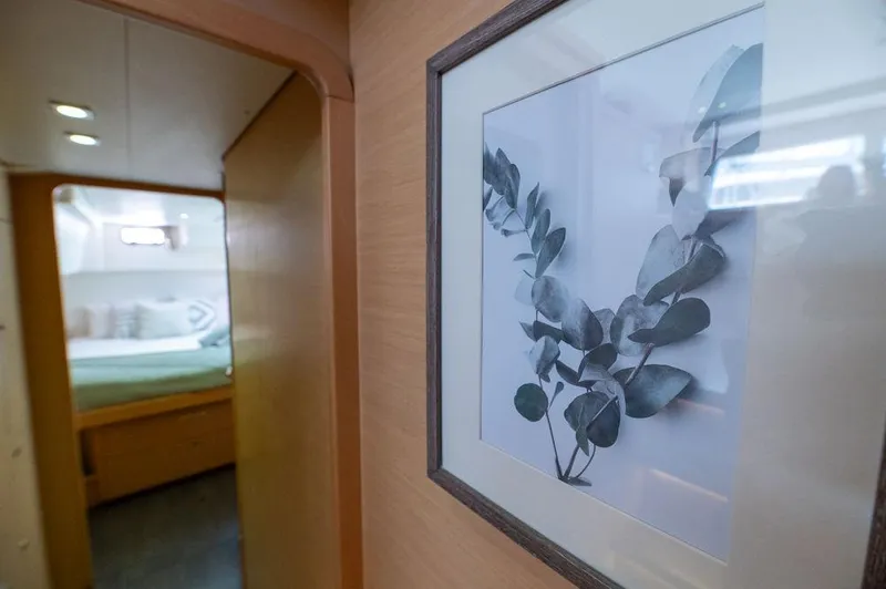 Miss Summer Yacht Photos Pics Interior of 2014 Lagoon 450 yacht with framed leaf artwork and cozy bedroom.