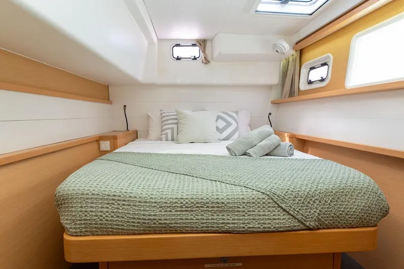 Miss Summer Yacht Photos Pics Luxurious cabin interior of 2014 Lagoon 450 catamaran with cozy bedding and natural light.