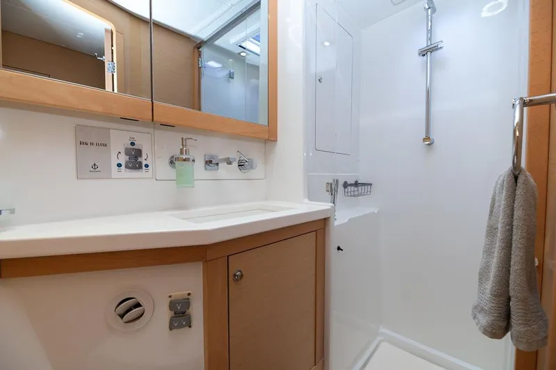 Miss Summer Yacht Photos Pics Bathroom interior of 2014 Lagoon 450 yacht with modern fixtures and wooden cabinetry.