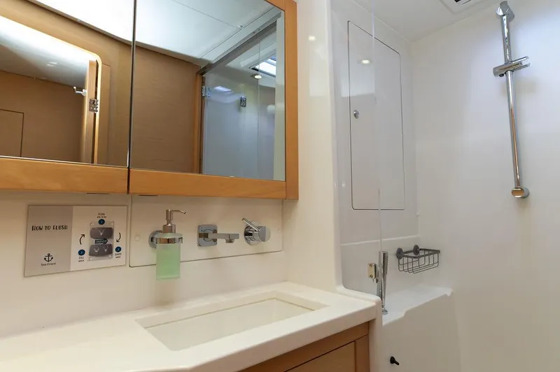 Miss Summer Yacht Photos Pics Bathroom interior of 2014 Lagoon 450 yacht, featuring modern fixtures and a sleek design.