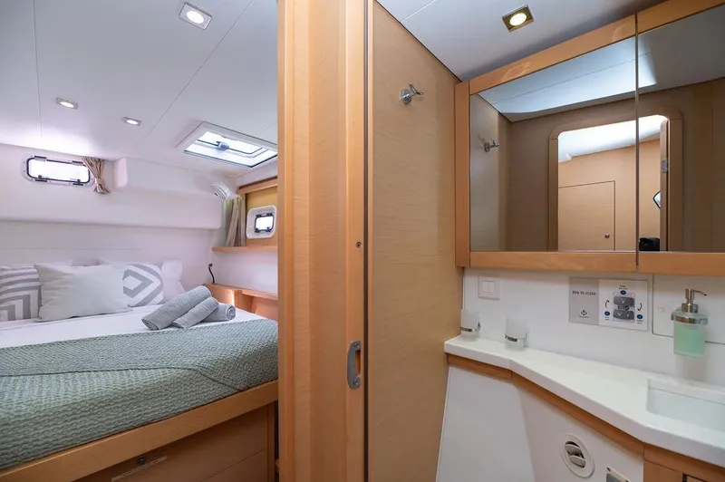 Miss Summer Yacht Photos Pics Luxurious interior of 2014 Lagoon 450 catamaran with cozy bedroom and modern bathroom.