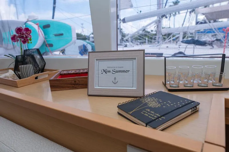 Miss Summer Yacht Photos Pics Interior of 2014 Lagoon 450 yacht with decor, framed sign, and notebooks.