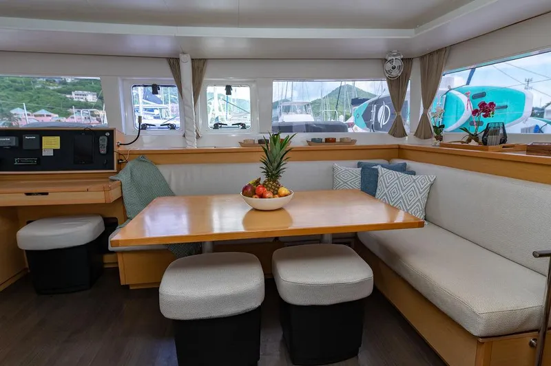 Miss Summer Yacht Photos Pics Interior of 2014 Lagoon 450 catamaran with dining area and fruit centerpiece.