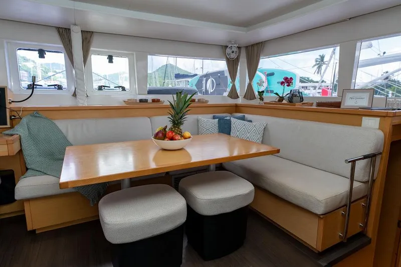 Miss Summer Yacht Photos Pics Interior of 2014 Lagoon 450 catamaran with cozy dining area and fruit centerpiece.