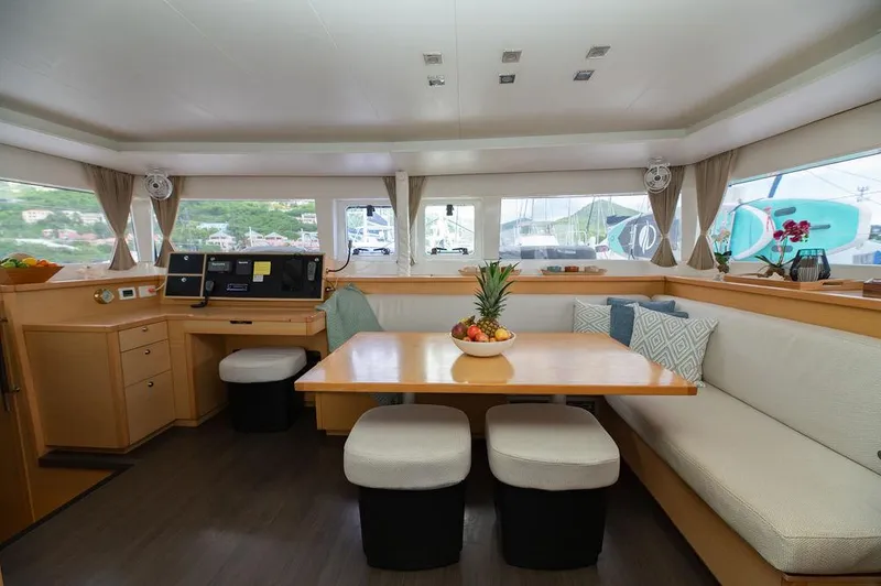 Miss Summer Yacht Photos Pics Interior of 2014 Lagoon 450 catamaran with dining area and navigation station.