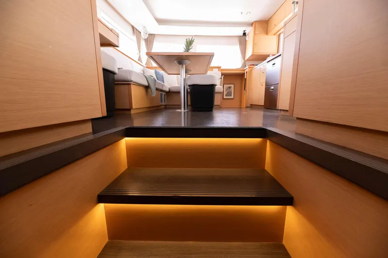 Miss Summer Yacht Photos Pics Luxurious interior of 2014 Lagoon 450 catamaran with modern lighting and wooden finishes.