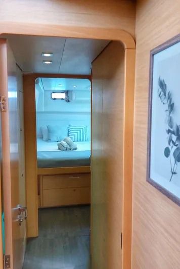 Miss Summer Yacht Photos Pics Interior view of 2014 Lagoon 450 yacht cabin with cozy bed and wooden finish.